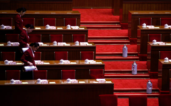 Tea ladies fill cups before the arrival of delegates to hear Chairman and Party Secretary of the Standing Committee of the National People's Congress (NPC) Wu Bangguo deliver the government's work report during the third plenary meeting of the NPC in Beijing March 9, 2012. REUTERS/David Gray (CHINA - Tags: POLITICS)
