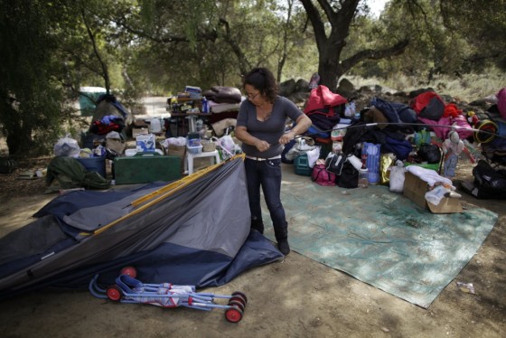 Angelica Cervantes, 36, packs up tents in the campground where she has been staying with her aunt Benita Guzman, 40, and their children, in Santa Paula.