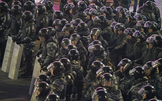 Russian police officers block a street near the site of a protest in downtown Moscow, Russia, Monday, March 5, 2012. Riot police on Monday broke up an opposition protest contesting Prime Minister Vladimir Putin's victory in Russia's presidential election, arresting dozens of participants, including prominent opposition leaders. The police action followed a rally in downtown Moscow that drew about 20,000 protesters angry over a campaign slanted in Putin's favor and reports of widespread violations in Sunday's ballot. (AP Photo/Mikhail Metzel)