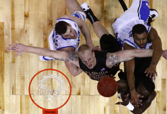 Florida State Seminoles center Jon Kreft (C) fights for a rebound with his teammate forward Okaro White (bottom R) against Duke Blue Devils forward Josh Hairston (top R) and forward Miles Plumlee (L) during their ACC college basketball tournament game in Atlanta, Georgia March 10, 2012. REUTERS/Chris Keane (UNITED STATES - Tags: SPORT BASKETBALL)