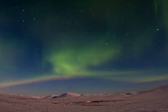 The aurora borealis is seen from Mile 7 on Beam Road above snow-covered tundras near Nome, Alaska March 10, 2012. A solar storm that shook the Earth's magnetic field on Thursday spared satellite and power systems as it delivered a glancing blow, although it could still intensify until early Friday, U.S. space weather experts said. REUTERS/Oscar Avellaneda-Cruz (UNITED STATES - Tags: ENVIRONMENT TPX IMAGES OF THE DAY)