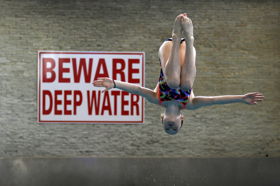 A member of Crystal Palace diving club dives during a training session in London March 9, 2012. Standing in neat lines in a south London gym, a squad of hand-picked, tracksuited youngsters stretch their arms in unison, counting together in Mandarin.Taking the proverb 'if you can't beat them, join them' quite literally, Crystal Palace diving club has turned to Chinese expertise to foster Britain's future Olympic hopes. Picture taken March 9, 2012. REUTERS/Stefan Wermuth (BRITAIN - Tags: SPORT OLYMPICS DIVING)