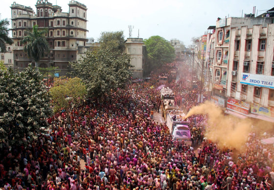 epa03142163 A truck sprays colored powder during a procession on the occasion of the Rangpanchami festival in Indore, India, 12 March 2012. The festival falls after the fifth day of Holi festival. EPA/SANJEEV GUPTA