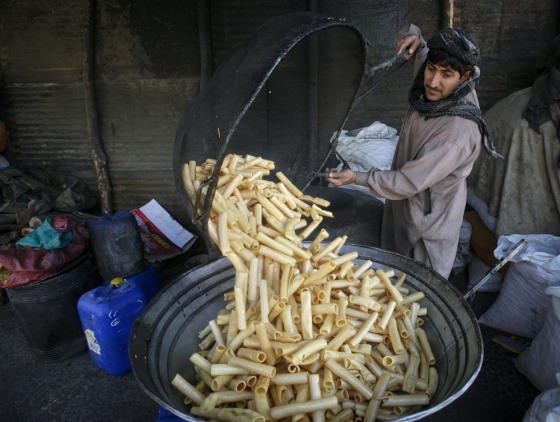 A man fries papadum rolls for sale at a workshop in Quetta March 13, 2012. REUTERS/Naseer Ahmed (PAKISTAN - Tags: SOCIETY FOOD)