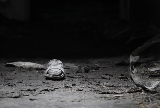 A sandal is seen in the Reda mosque in Brussels, Tuesday, March 13, 2012. A mosque near Brussels was the target Monday evening of an arson attack in which the imam died, Belgian authorities said late Monday. (AP Photo/Yves Logghe)