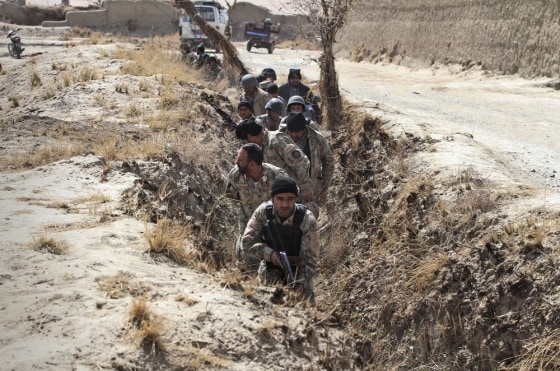 Afghan security forces take up positions in a dried water canal after Taliban militants opened fire on a delegation of senior Afghan officials in Panjwai, Kandahar province south of Kabul, Afghanistan, Tuesday, March. 13, 2012. Taliban militants opened fire Tuesday on a delegation of senior Afghan officials including two of President Hamid Karzai's brothers visiting villages in southern Afghanistan where a U.S. soldier is suspected of killing 16 civilians. (AP Photo/Allauddin Khan)