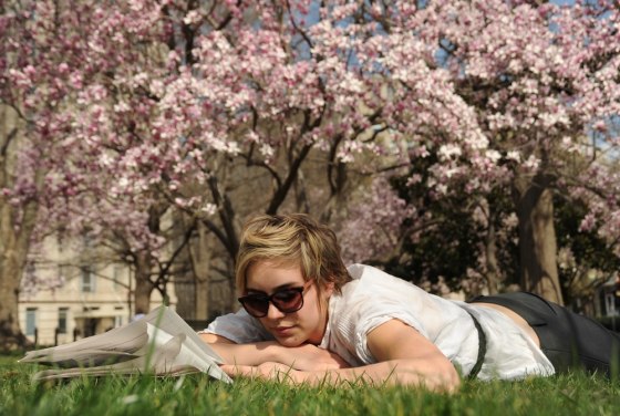 Zosia Sztykowski relaxes in Lafayette Park on a warm sunny Spring day March 13, 2012 in Washington, DC. Temperatures soared into the upper 70'sF, (21C) and are expected to hold through the week. AFP PHOTO/Karen BLEIER (Photo credit should read KAREN BLEIER/AFP/Getty Images)