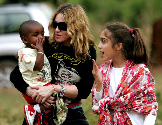 ** STAND-ALONE PHOTO PACKAGE FOR USE WITH MADONNA'S 50TH BIRTHDAY - FILE ** In this April 17, 2007 file photo, Madonna holds her adopted son David Banda in her arms as her daughter Lourdes, looks on, at the Home of Hope orphanage in Mchinji, Malawi. (AP Photo/Karel Prinsloo, File)