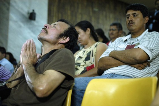 A man whose relatives were assassinated at Las Dos Erres village in 1982 gestures while listening the sentence to former Army Special Forces member Pedro Pimentel Rios at the Supreme Court of Justice in Guatemala City on March 12, 2012. A Guatemalan court sentenced Pimentel to 6,060 years in prison because of his participation in a 201 peasants massacre in 1982. AFP PHOTO / Jose Miguel LAM A (Photo credit should read Jose Miguel Lam/AFP/Getty Images)