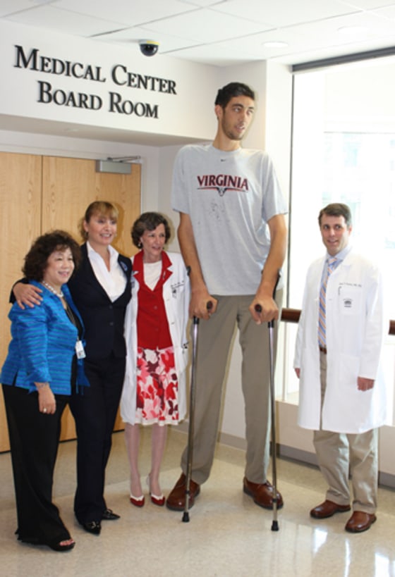 Sultan Kosen, the world's tallest man according to the Guiness book of records, received treatment at the University of Virginia Medical Center. Dr. Jason Sheehan (far right) performed radiosurgery to a tumor in Kosen's pituitary gland to stop his excess production of growth hormone. His endocrinologist, Mary Lee Vance, on Kosen's right, placed him on a new medication to help stop his growth. Here's the photo. Caption info is below: (Left to right) - Sophie Yu, Kelly Garrett, Mary Lee Vance, MD, Sultan Kosen and Jason Sheehan, MD