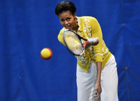 US First Lady Michelle Obama plays tennis while attending a mini-Olympics event with local school children at American University's Bender Arena March 13, 2012 in Washington, DC. The event is in celebration of the 2012 London Summer Olympics and the First Lady's "Letâ€™s Move!" children fitness initiative. AFP PHOTO/Mandel NGAN (Photo credit should read MANDEL NGAN/AFP/Getty Images)