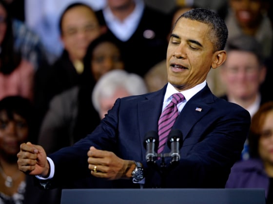 President Barack Obama mimics trying to read a mortgage loan contract that he and first lady Michelle Obama signed to purchase their first condo, while speaking at the James Lee Community Center in Falls Church, Wednesday, Feb. 1, 2012. (AP Photo/Cliff Owen)