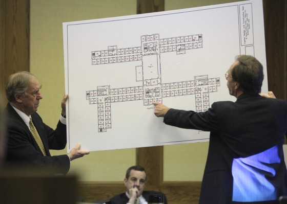 Defense attorneys Peter Messitt, right, and William “Bill” Broaddus, left, hold an enlarged map of the fourth floor of West Ambler Johnston Hall on the Virginia Tech campus in Montgomery County Circuit Court in Christiansburg, Va. onWednesday March 14 2012. Jurors began deliberating Wednesday over a lawsuit filed by the parents of two students slain in the 2007 Virginia Tech massacre claiming school officials botched their response when the first reports came in that a gunman was on campus. Attorneys for the university have countered that there was no way to anticipate the man who committed those first two killings April 16 in a dormitory would carry out the deadliest mass shooting in modern U.S. history. (AP Photo/The Roanoke Times, Matt Gentry)