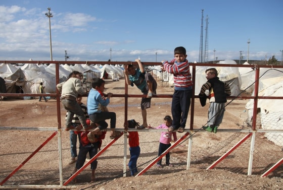 Syrian refugees play at the Reyhanli refugee camp in Hatay province on the Turkish-Syrian border March 15, 2012. A government offensive in Syria's northwest has sharply increased the flow of refugees into Turkey, with about a thousand crossing in the last 24 hours, Turkish officials said on Thursday. The numbers fleeing was expected to grow further as long as fighting continued around the town of Idlib, close to the Turkish border, one Turkish official said; but he declined to say how many more Turkey was expecting. REUTERS/Jonathon Burch (TURKEY - Tags: POLITICS SOCIETY IMMIGRATION CIVIL UNREST)