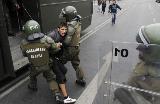 Riot police detain a student during a protest against the government to demand changes in the public state education system in Valparaiso city, about 121 km (75 miles) northwest of Santiago, March 15, 2012. Chilean students have been protesting against what they say is the profiteering in the state education system. REUTERS/Eliseo Fernandez (CHILE - Tags: EDUCATION CIVIL UNREST)