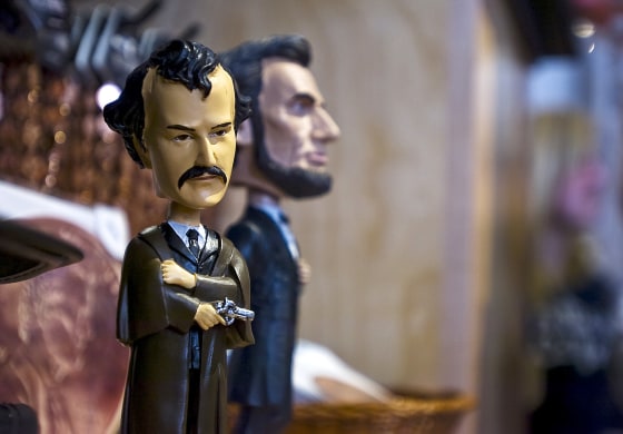 NEWS THE EVENING SUN -- SHANE DUNLAP A John Wilkes Booth bobblehead for sale alongside Abraham Lincoln at the Gettysburg Visitor's Center gift shop.