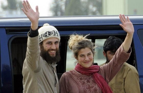 Swiss couple Olivier David Och (L) and Daniela Widmer (R) wave upon their arrival at the Qasim base in Rawalpindi on March 15, 2012. A Swiss couple held captive by the Pakistani Taliban for over eight months were recovered safely, claiming they escaped their captors in the lawless tribal belt, the army said. AFP PHOTO/Farooq NAEEM (Photo credit should read FAROOQ NAEEM/AFP/Getty Images)