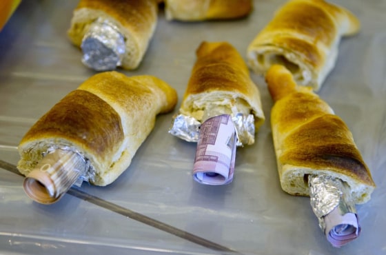 Money concealed in pastries that the German customs agency Zoll seized during an anti-money laundering operation, is displayed before the agency's annual statistics news conference at the finance ministry in Berlin on Friday.