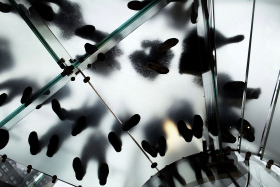 NEW YORK, NY - MARCH 16: People wait on a set of stairs to get into the Apple store to purchase the new iPad as they went on sale around the world March 16, 2012 in New York City. Simply called the iPad, the new tablet replaces the iPad 2 and features a high-pixel-count "retina display." Hundreds of people waited in line all night to be the first into the flagship Apple Store on Manhattan's Fifth Avenue. (Photo by Spencer Platt/Getty Images) *** BESTPIX ***