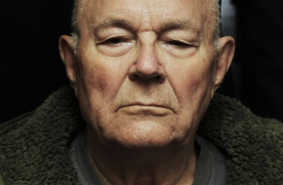 MUNICH, GERMANY - FILE: John Demjanjuk emerges from a Munich court after a judge sentenced him to 5 years in prison for charges related to 28,060 counts of accessory to murder on May 12, 2011 in Munich, Germany. Former Nazi death camp guard John Demjanjuk, sentenced to five years in prison in 2011, has died at the age of 91, Bavarian state radio reported on Saturday, March 17, 2012. (Photo by Johannes Simon/Getty Images)