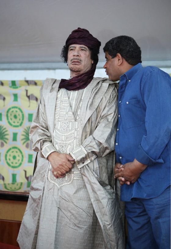 FILE - In this Tuesday, Oct. 6, 2009 file photo, intelligence chief Abdullah al-Senoussi, right, whispers to Libyan leader Moammar Gadhafi in Sabha, Libya. A local spokesman for Libya's new leadership announced Tuesday, Nov. 22, 2011 that former intelligence chief Abdullah al-Senoussi was captured over the weekend and is being held in the southern city of Sabha. (AP Photo/Abdel Magid al-Fergany, File)