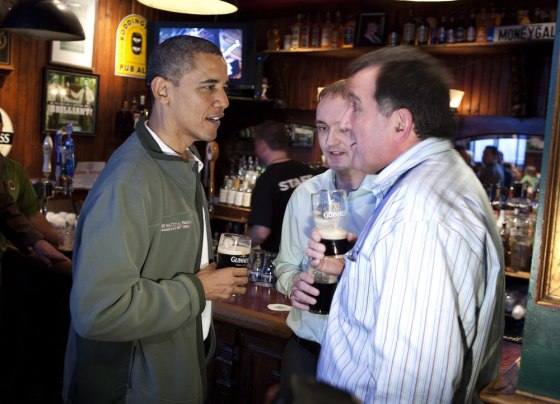 epa03149212 U.S. President Barack Obama (L) celebrates St. Patrick's day at the Dubliner Irish pub with Ollie Hayes, (R) owner of the pub in Moneygall, Ireland and Henry Healy (C), Obama's cousin from Moneygall, Ireland, in Washington, DC,USA, 17 March 2012. EPA/JOSHUA ROBERTS/POOL