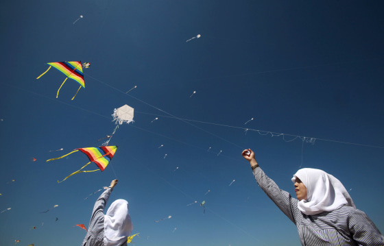 epa03150277 Palestinian children fly kites during the solidarity with Japan event, near a Japanese-funded housing project in Khan Younis, at the southern Gaza Strip, 18 March 2012. The event was organized by the United Nations Relief and Works Agency (UNRWA) to mark the first anniversary of the 9.0-magnitude earthquake and subsequent tsunami that devastated northeastern Japan and triggered a nuclear disaster at the Fukushima Daiichi Nuclear Power Plant. EPA/ALI ALI