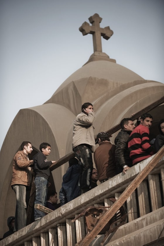 Egyptian Christian Copts wait in a queue to enter Saint Mark's Coptic Cathedral in Cairo's al-Abbassiya district on March 19, 2012 where tens of thousands of grieving Coptic Christians bid farewell to Pope Shenuda III, who died on March 16 at the age of 88 after a long illness, setting in motion the process to elect a new patriarch for the Middle East's largest Christian community. AFP PHOTO/GIANLUIGI GUERCIA (Photo credit should read GIANLUIGI GUERCIA/AFP/Getty Images)