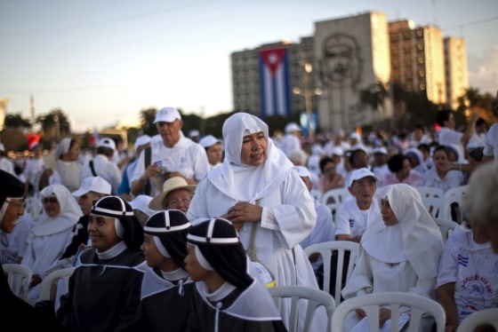 Nuns wait as worshippers gather in Revolution Square for the arrival of the Pope Benedict XVI to celebrate a Mass in Havana, Cuba, Wednesday, March 28, 2012. Pope Benedict XVI wraps up his visit to Cuba on Wednesday with an open-air Mass in the shrine of the Cuban revolution.(AP Photo/Ramon Espinosa)