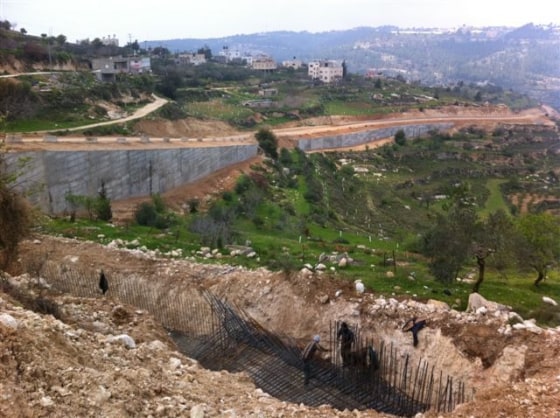 Parts of the Israeli security wall are still under construction, while others are already snaking through the West Bank village Al-Walaja.