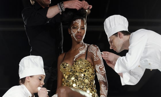 A model receives the last touch-ups before presenting a creation at the first Salon du Chocolat.