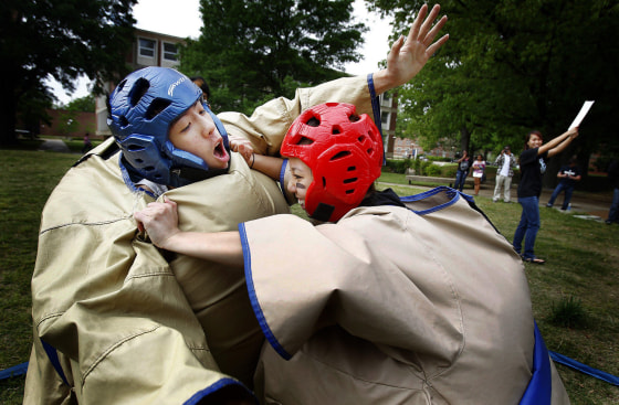 University of Memphis students Mason Lin, left, and Christina Dang battle it out in a sumo competition Friday March 30, 2012, during the school's inaugural Asian American Awareness Week sponsored by the Asian American Association in Memphis, Tenn. This is the first year for the U of M Asian American Association on campus and the group has seen its numbers grow from 15 members last semester to over 80 this semester and hopes the event will help bring in more new members and also shine a light on the discrimination of Asian Americans including the recent racial slurs towards NBA player Jeremy Lin of the New York Knicks.