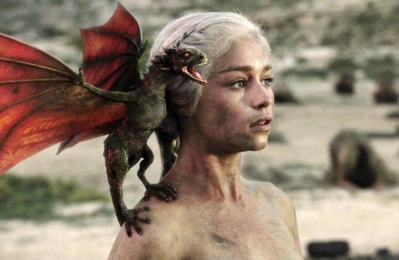 A freshly hatched dragon perches on the shoulder of Daenerys in