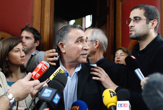 Said Hicheur (center), father of Franco-Algerian nuclear physician Adlene Hicheur, and Halim (right), Adlene's brother, outside the Paris courthouse Friday.