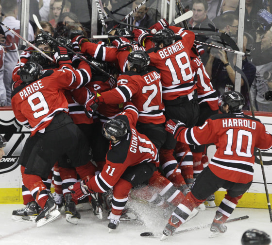 The New Jersey Devils celebrate after beating the New York Rangers 3-2 in overtime of Game 6.