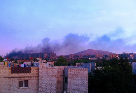 A picture released by the Syrian opposition's Shaam News Network allegedly shows smoke billowing following a blast targeting a Syrian security forces vehicle on the ringroad outside the Damascus Mazze district early Sunday.