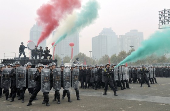 Police officers and forces from the Special Weapons and Tactics (SWAT) practice to disperse crowd in a joint drill to reinforce security for the coming 18th National Congress of the Communist Party of China, in Zhengzhou, Henan province, on Tuesday.