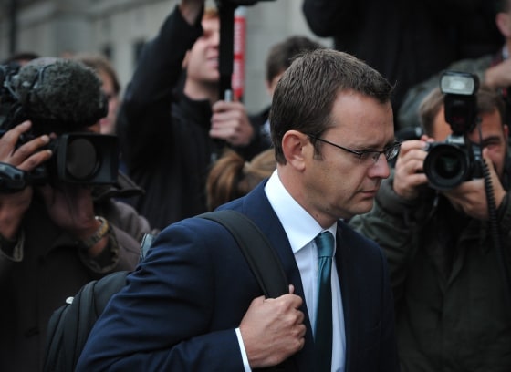 Former News of the World editor and Prime Minister David Cameron's ex-media chief Andy Coulson, seen here in September, will be charged along with former News International chief executive Rebekah Brooks for making illegal payments in exchange for information.