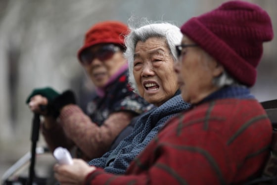 Women sit on a bench at a park in downtown Shanghai in this March 16, 2012 file photograph. Policy makers and economists have long been worried about the financial burden of China's expanding patchwork of pension schemes, but those concerns have recently escalated as its rural pension scheme took off in the past three years.
