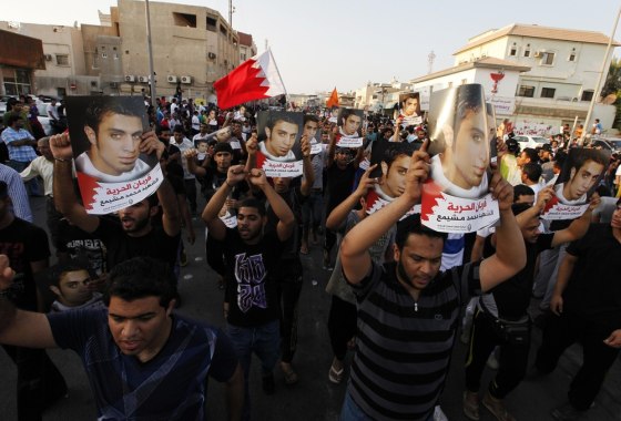 Friends and well-wishers of Mohammed Ali Moshaima carry his photo as they march during the funeral procession in the village of Jidhafs, west of Manama, Bahrain, October 2, 2012. Moshaima, who was sentenced to 7 years in prison in the protest case at the Bahrain Financial Harbour, died from sickle-cell disease, Bahrain authorities said.