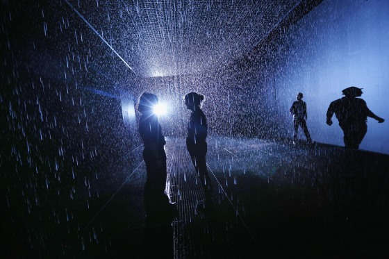 Members of the public experience the 'Rain Room' art installation by 'Random International' in The Curve at the Barbican Centre on Oct. 3, 2012 in London, England.