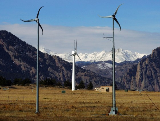 Wind turbines at the National Renewable Energy Laboratory Wind Farm are shown in front of snowcapped mountains near Boulder, Colo.