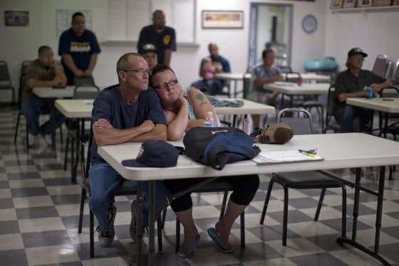 Dawn, right, and Randy Cornell, watch the presidential debate at the United Steelworkers Local 4856 Union Hall with fellow union members,in Henderson, Nevada.