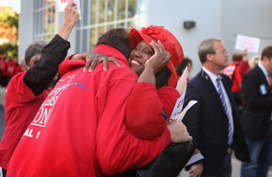 Chicago Teachers Union (CTU) delegates embrace after voting to end their strike on September 18, 2012 in Chicago, Illinois.