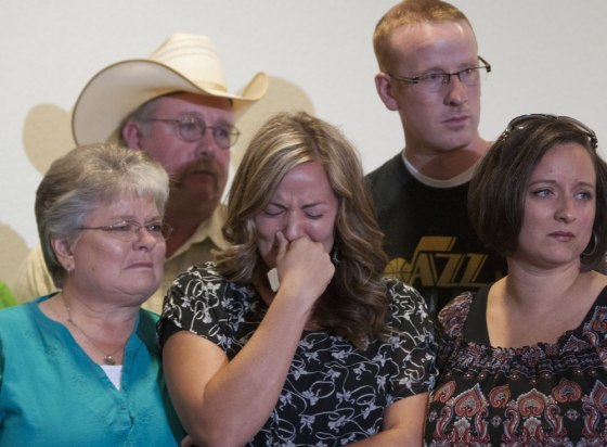 Christy Ivie, center, wife of Nicholas Ivie, holds back tears as she is surrounded by her father, Tracy Morris, and mother, DeAnn Morris, left, and her sister, Jan Cloward, and brother, Travis Morris, right, during news conference on Tuesday.