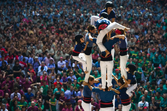Members of the Colla 'Caprogossos de Mataro' climb up as they construct a human tower during the 24th Tarragona Castells Comptetion on Oct. 7, in Tarragona, Spain. The 'Castellers' who build the human towers with precise techniques compete in groups, known as 'colles', at local festivals with aim to build the highest and most complex human tower. The Catalan tradition is believed to have originated from human towers built at the end of the 18th century by dance groups and is part of the Catalan culture.