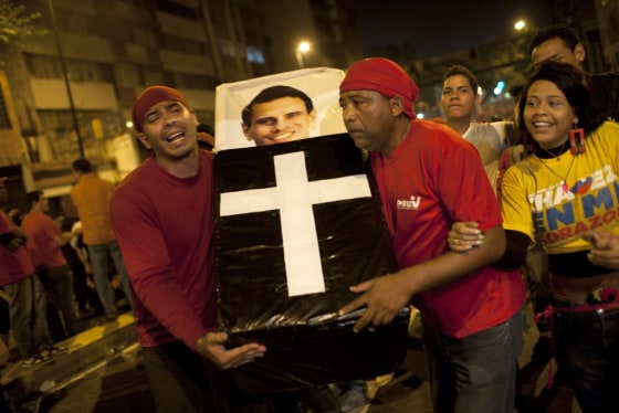 Supporters of Hugo Chavez perform a mock funeral for opposition candidate Henrique Capriles as they celebrate in downtown Caracas on Oct. 7, 2012.