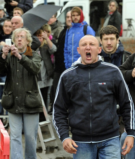 A member of the public reacts as a prison van transports Mark Bridger from Aberystwyth Magistrates Court in Mid Wales on Oct. 8, 2012. Bridger appeared at court on Monday charged with the murder of missing school girl April Jones, child abduction and attempting to pervert the course of justice by disposing of her body.