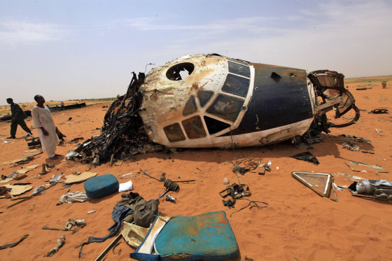 People look at the remains of a Sudanese military plane after it crashed at the North Korodofan State border near the capital of Khartoum, on Oct. 8, 2012. The Antonov 12 transport plane, carrying personnel and equipment to the strife-torn Darfur region, crashed near Khartoum on Sunday, killing 15 people on board, the army said.