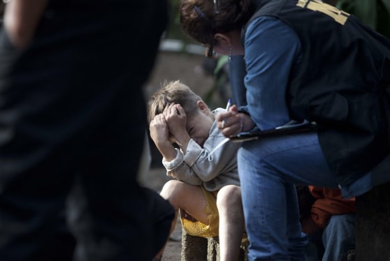 Carlos Daniel Gonzalez, 6, shows authorities the way he hid from unknown gunmen that killed his parents and other relatives in the municipality of Villa Canales on Oct. 9.